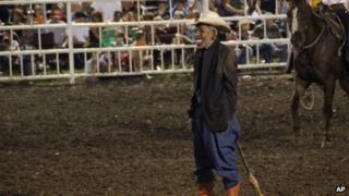 An unidentified rodeo clown dons an Obama mask at the Missouri State Fair (10 August 2013)