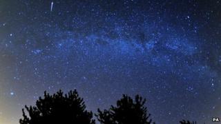 A meteor is seen during the Perseids meteor shower over the Cotswold Water Park near Cirencester, Gloucestershire