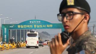 A bus carrying South Korea's delegation leaves for Kaesong on 14 August 2013