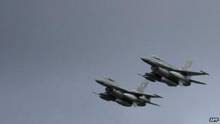 American, US-built F-16 jets fly over the Krzesiny air base in Poznan during a ceremony 09 November 2006