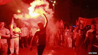 Anti-government protesters hold flares and shout slogans during demonstration in Tunis. 24 Aug 2013