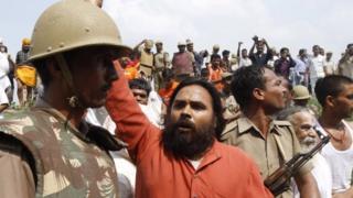 Activists of the Hindu right-winged Vishwa Hindu Parishad, or World Hindu Council (VHP) scuffle with Indian policemen before getting detained at Ayodhya, India, Sunday, Aug. 25, 2013.