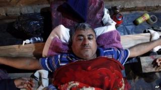 Bus driver lies with his hands nailed to a wooden cross during a protest in in the outskirts of Asuncion, Paraguay, Aug. 16, 2013.