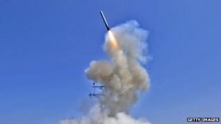The US Navy guided-missile destroyer USS Barry (DDG 52) launches a Tomahawk cruise missile in support of Operation Odyssey Dawn on 29 March 2011 from the Mediterranean Sea