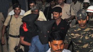 Two arrested suspects (C, in black hoods) including Yasin Bhatkal, the alleged founder of militant group Indian Mujahideen, are brought to a court by police in Motihari, India"s Bihar state, on August 29, 2013.