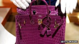 Purple crocodile skin handbag