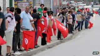 Tunisian anti-government protesters with national flags form a human chain. Photo: 31 August 2013