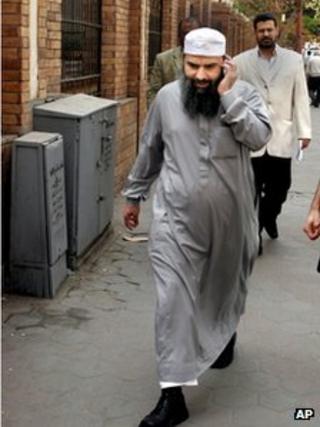 Egyptian cleric Osama Hassan Mustafa Nasr talks on his mobile as he walks at a Cairo street on 11 April 2007.
