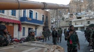 Syrian pro-government troops are seen on the streets of the Christian town of Maaloula