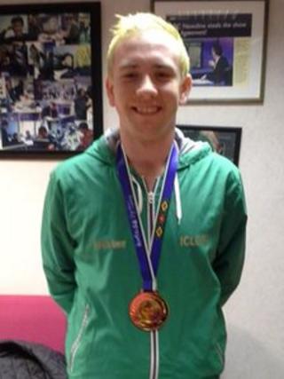 Shane McKeever proudly displays his gold medal