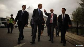 European Commission inspector, centre, walks with Gibraltar representatives