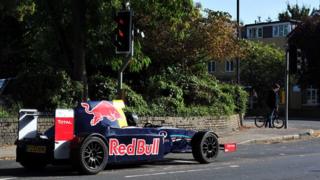 Russ Bost's racing style car waiting at traffic lights