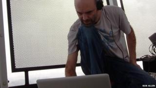 Cian Ciaran with a laptop