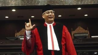 In this 20 August 2013 photo, Indonesia's top judge Akil Mochtar poses for photos during a swearing-in ceremony in Jakarta