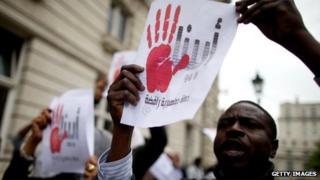 Members of the campaign group Sudan Change Now protesting outside the Sudanese embassy in London