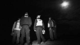 Police at night near badger cull protesters