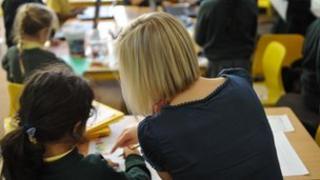 Teacher helping pupil