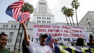 Ipolito Nurez celebrates outside City Hall after California Governor Jerry Brown signed the bill AB 60, which allows immigrants in the country illegally to obtain driver licenses 3 October 2013