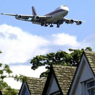 Aircraft flying over houses
