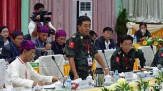 General Gwan Maw (C) of the Kachin Independence Army (KIA) speaks during a meeting between representatives of the Myanmar government and a delegation of the rebel KIO (Kachin Independence Organization) in Myitkyina, in the country's northern Kachin state on 8 October 2013.