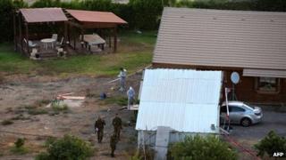 Israeli soldiers and policemen inspect the scene of an attack at a house in the Israeli Shadmot Mehola settlement in the Jordan Valley in the West Bank on 11 October 2013