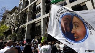 Supporters wave banner with photo of Cristina Fernandez de Kirchner