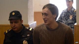 Pavel Dmitrichenko is escorted into Tuesday's court hearing