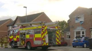 Scene of fire with fire engine and police tape