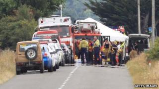 A Police photographer is lifted up in a Fire service ladder unit at the hot air balloon accident site on 7 January 2012 in Carterton, New Zealand