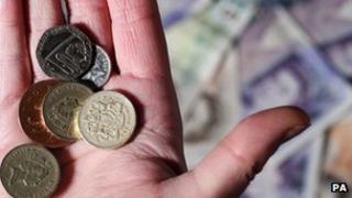 Hand holding pound coins