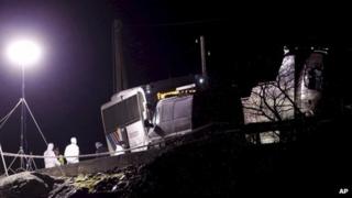 Police investigators stand outside the hijacked bus