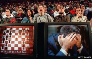 Chess enthusiasts watch Garry Kasparov on a television monitor in 1997