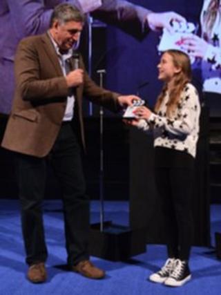 Agnieszka Kolaczynska receiving her award from actor Jim Carter