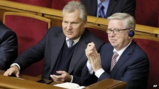 Former President of the European Parliament Patrick Cox, right, and former Polish President Aleksander Kwasniewski, watch a parliament session in Kiev, Ukraine