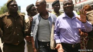 Nguza Viking, known as Babu Seya (R) and his son Johnson Nguza, known as Papii Kocha (C) at a court appearance in Dar es Salaam in October 2013