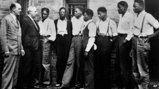 Seven of the nine Scottsboro Boys met with lawyer Samuel Leibowitz (second from left) on 1 May 1935