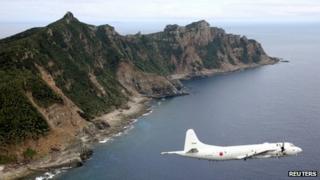Japan Maritime Self-Defense Force's PC3 surveillance plane flies around the disputed islands in the East China Sea, known as the Senkaku isles in Japan and Diaoyu in China, in this October 13, 2011 file photo