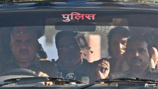 Rajesh Talwar (second from left) and his wife Nupur Talwar (second from right) arrive at a prison in India in 25 November 2013