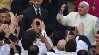 Pope Francis greets a crowd in the Vatican on November 24