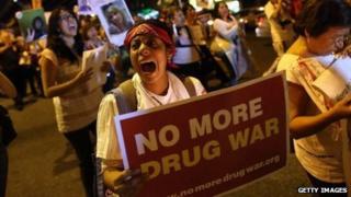 An anti-drug-war protester holds up a sign in New York City