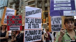 Activists hold posters with pictures and names of missing women at an event on November 3, 2010