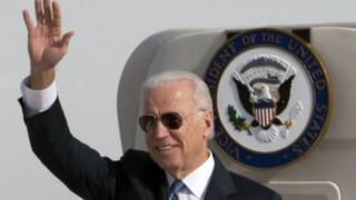 U.S. Vice President Joe Biden waves as he walks out of Air Force Two at the airport in Beijing, China, Wednesday, Dec. 4, 2013.