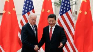 Chinese President Xi Jinping (R) shakes hands with US Vice President Joe Biden (L) inside the Great Hall of the People in Beijing on December 4, 2013.
