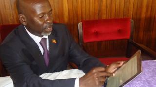 Ugandan MP Elijah Okupa with his iPad