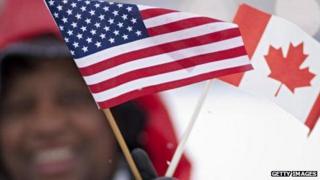 A spectator waves Canadian and American flags before a meeting between US President Barack Obama and Canadian Prime Minister Stephen Harper in 2009.