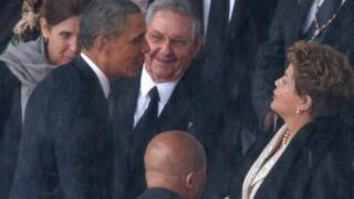 US President Barack Obama greets Cuban President Raul Castro and Brazilian President Dilma Rousseff at Nelson Mandela's memorial service on December 10, 2013.