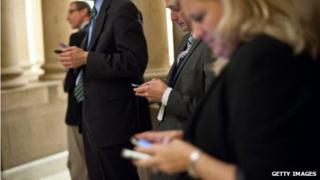 People checking their mobile phones