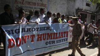 A police officer stops a group of Indians protesting against the arrest of Devyani Khobragade, an Indian consular officer in New York, outside the U.S consulate in Hyderabad, India, Monday, Dec. 16, 2013.