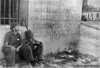 Two soldiers sitting by a wall
