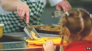 Girl being served school meal